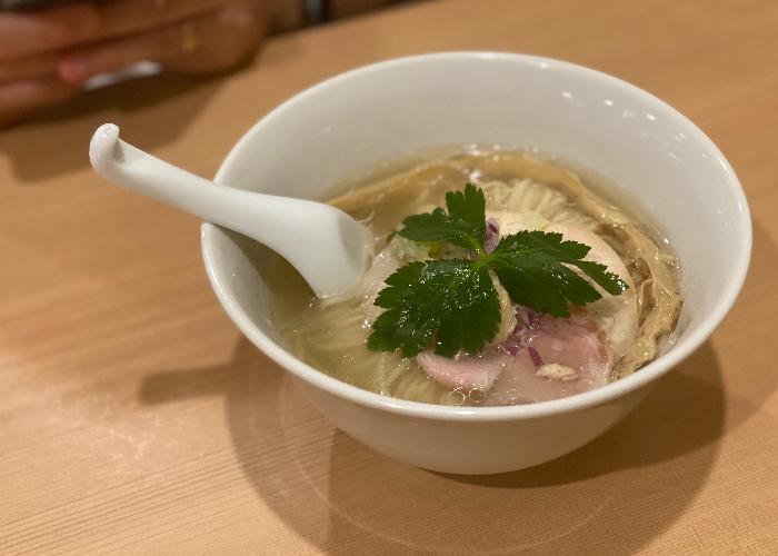 A simple bowl of ramen at Mensho Ichiryu Manbai, focusing on chewy noodles and tender meat.